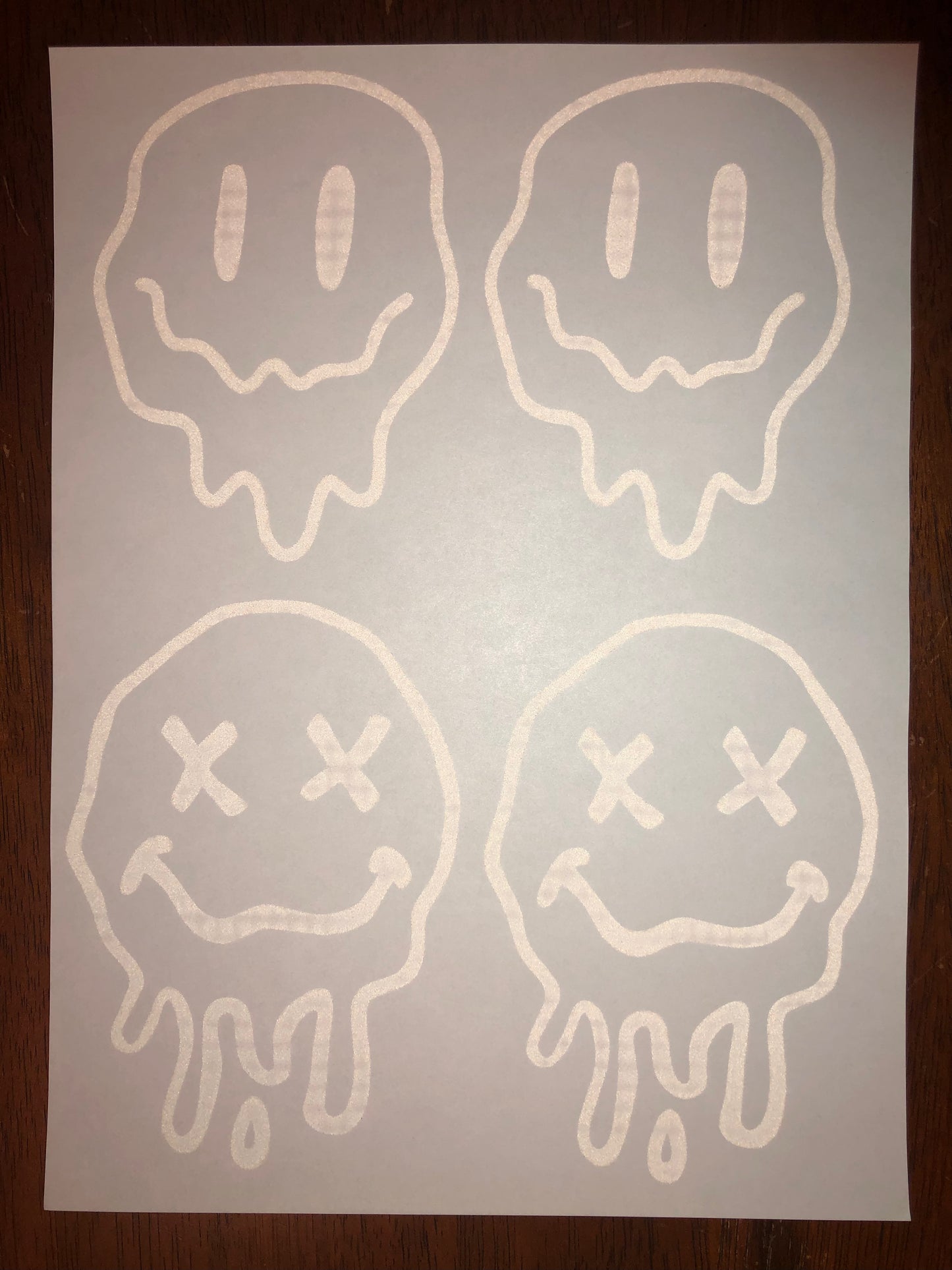 White melty smiley face screen transfer t-shirt